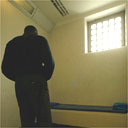 Man pacing prison cell